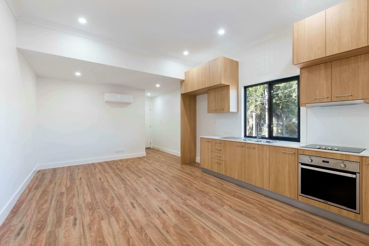 Finished open-plan kitchen and living space with new flooring