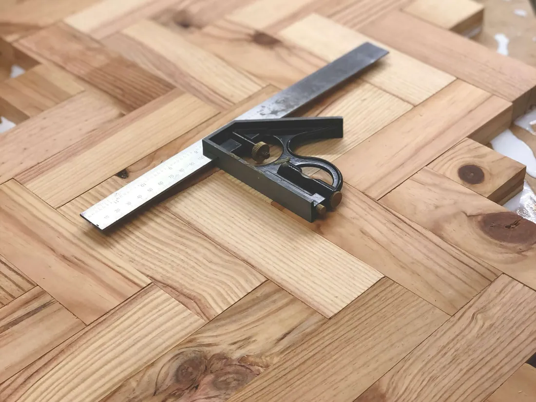 Measuring tools on a herringbone timber floor