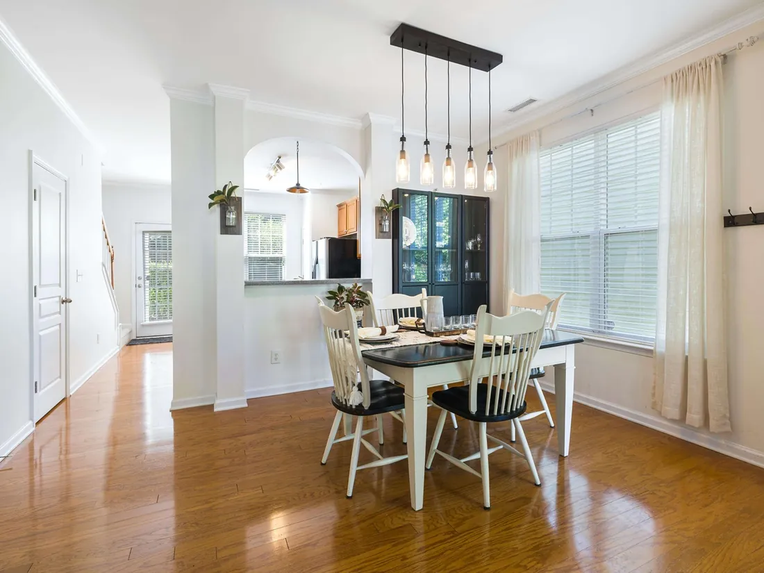 Bright dining area with a honey-toned timber floor