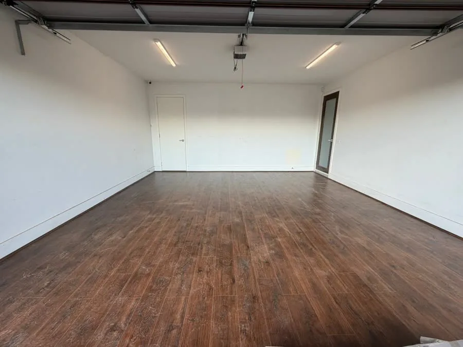Dark walnut-look flooring in a converted garage space